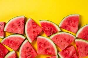 Beautiful pattern with fresh watermelon slices on yellow bright